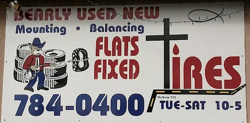Bearly Used and New Tires shop sign showing services and phone number